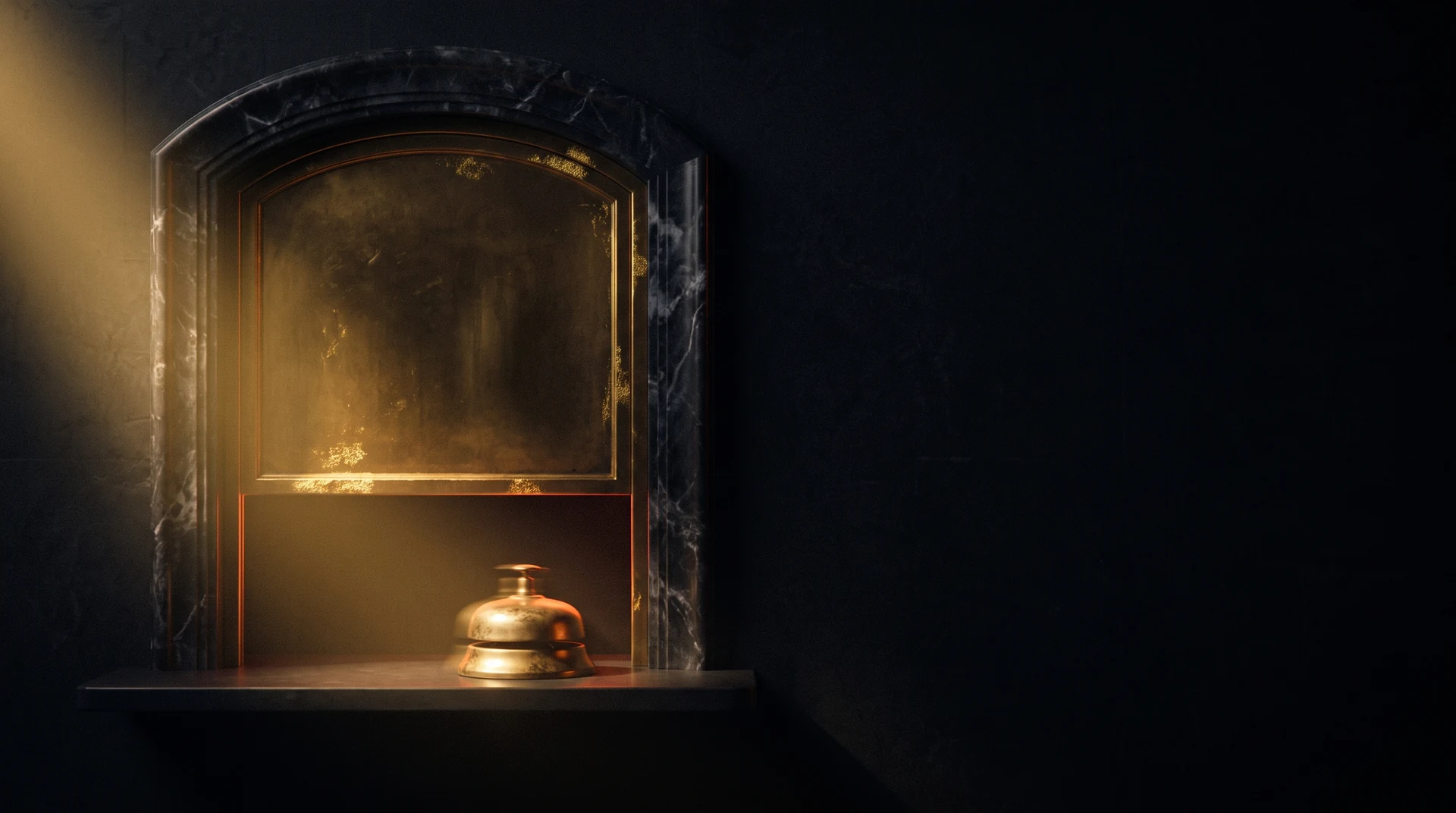 A closed brass service window in dark marble with a small bell on the counter and nobody behind the glass